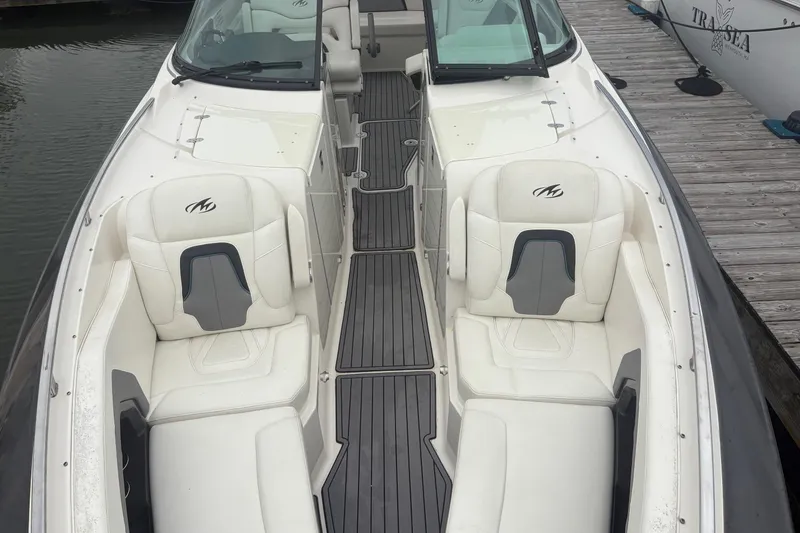 Slide: The Image of 2014 Monterey 328 Super Sport boat with white seating and sleek design at a dock. - 22