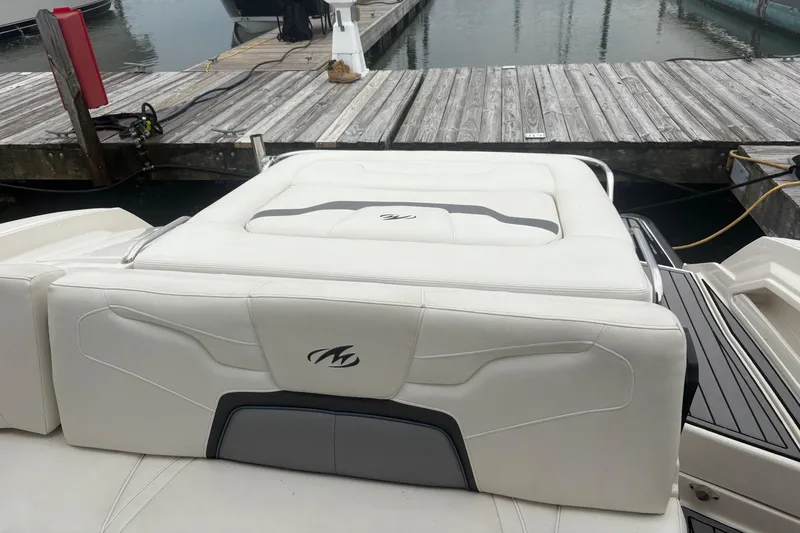 Slide: The Image of 2014 Monterey 328 Super Sport boat at dock with white seating and logo. - 25