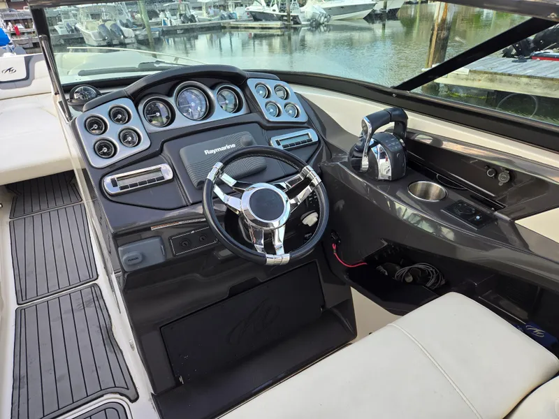 Slide: The Image of 2014 Monterey 328 Super Sport boat dashboard with steering wheel and controls. - 5