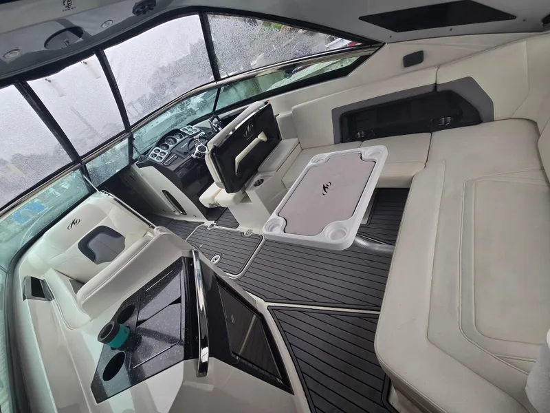 Slide: The Image of Interior of a 2014 Monterey 328 Super Sport boat with seating and helm. - 6