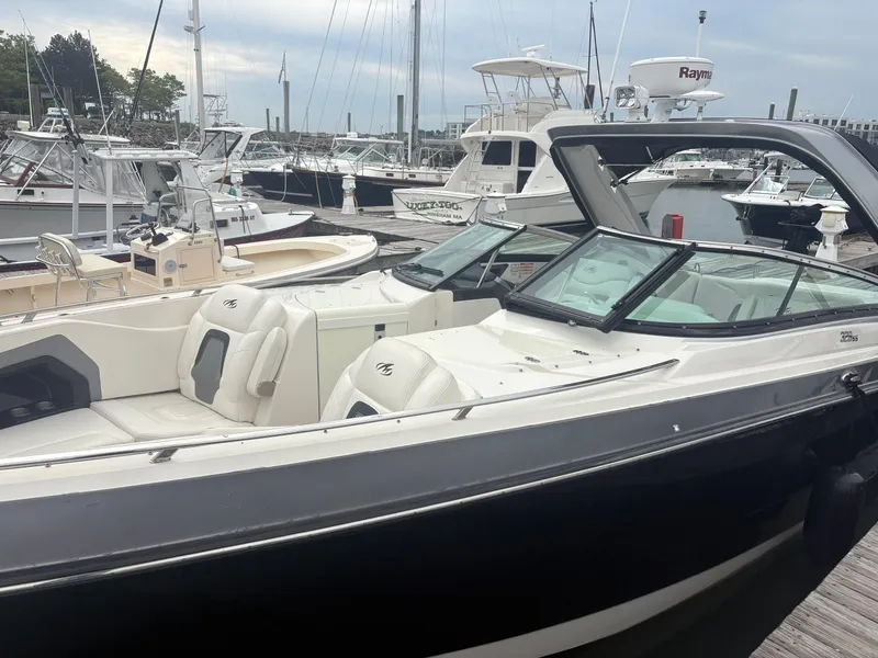 Slide: The Image of 2014 Monterey 328 Super Sport boat docked at a marina, featuring sleek design and comfortable seating. - 7