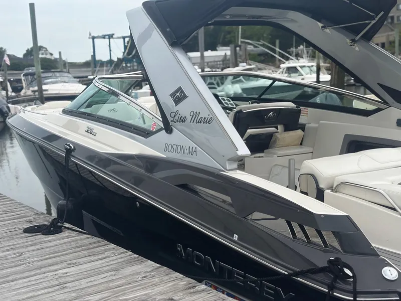 Slide: The Image of 2014 Monterey 328 Super Sport boat docked, featuring sleek design and luxurious seating. - 9