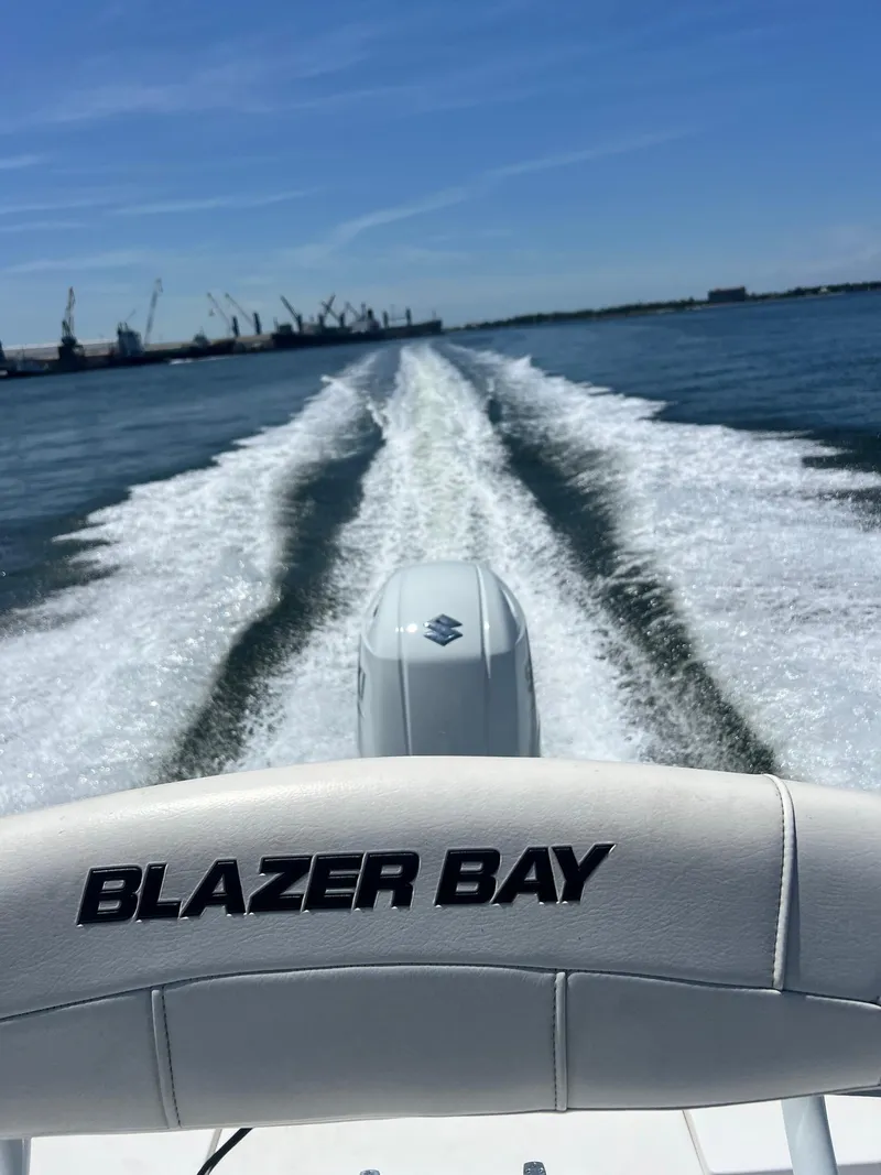 Slide: The Image of 2021 Blazer Bay 2200 boat cruising on water, leaving a wake behind. - 13