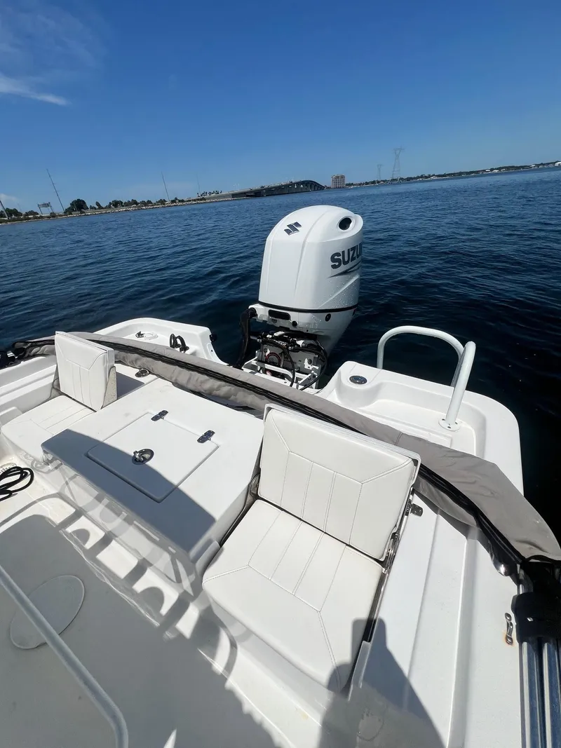 Slide: The Image of 2021 Blazer Bay 2200 boat with Suzuki outboard motor on calm water. - 15