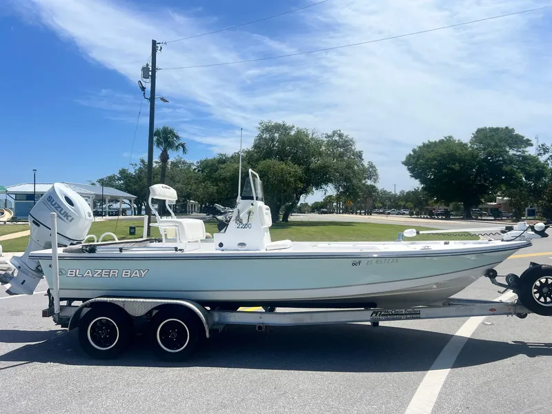 Slide: The Image of 2021 Blazer Bay 2200 boat on trailer, parked outdoors under clear sky. - 5