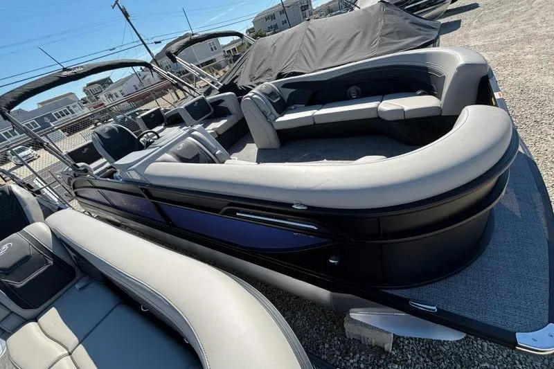 The Image of 2026 Barletta C24M pontoon boat with sleek design, docked outdoors. - 0