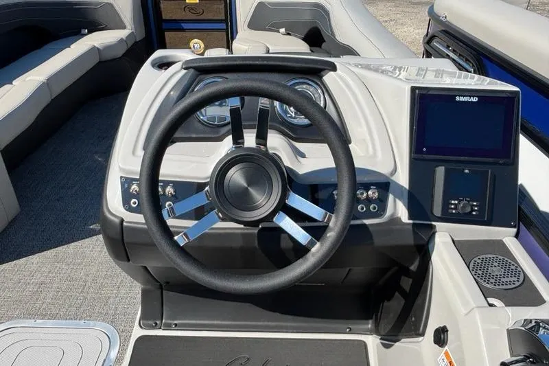 Slide: The Image of 2026 Barletta C24M boat dashboard with steering wheel and Simrad display. - 11