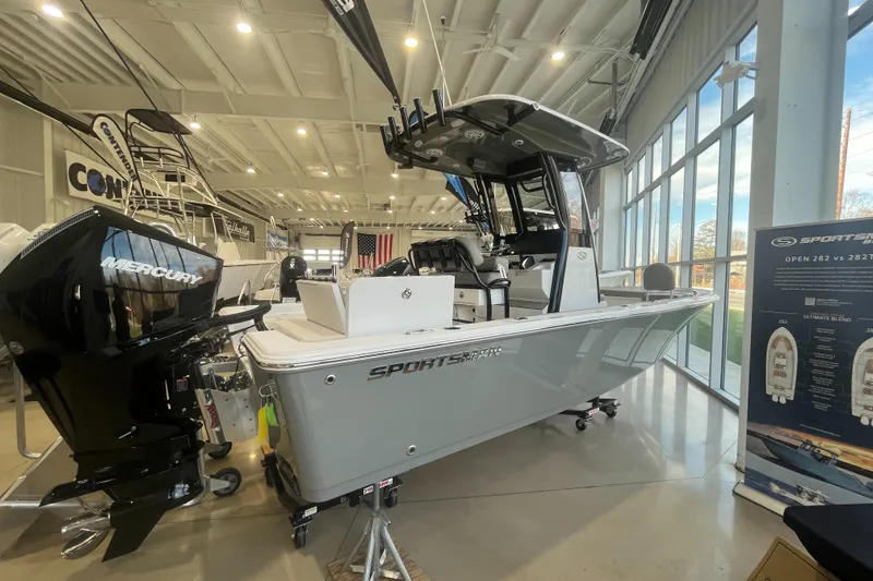 Slide: The Image of 2025 Sportsman Masters 227 Bay Boat displayed indoors with Mercury engine. - 10