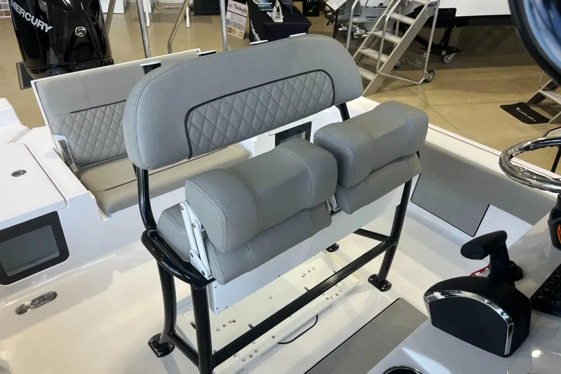 Slide: The Image of 2025 Sportsman Masters 227 Bay Boat interior with cushioned seating and control panel. - 3