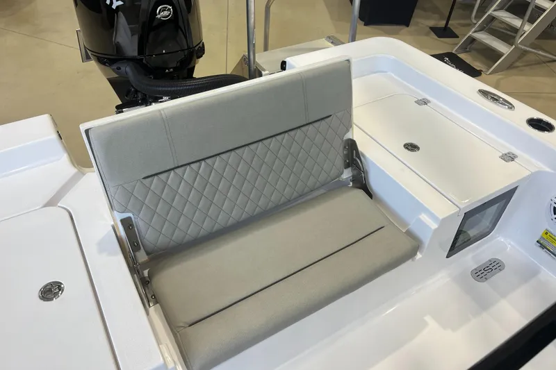 Slide: The Image of 2025 Sportsman Masters 227 Bay Boat with cushioned seating and storage compartments. - 7