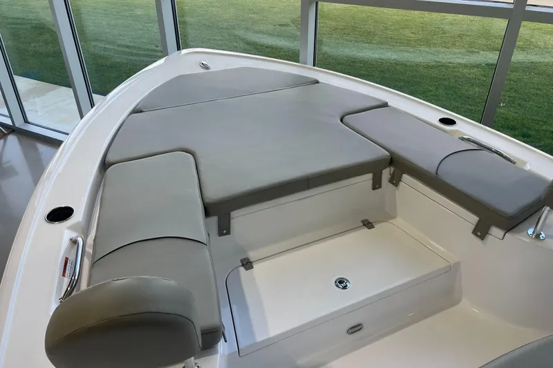 Slide: The Image of 2025 Sportsman Masters 227 Bay Boat interior with cushioned seating and storage. - 8