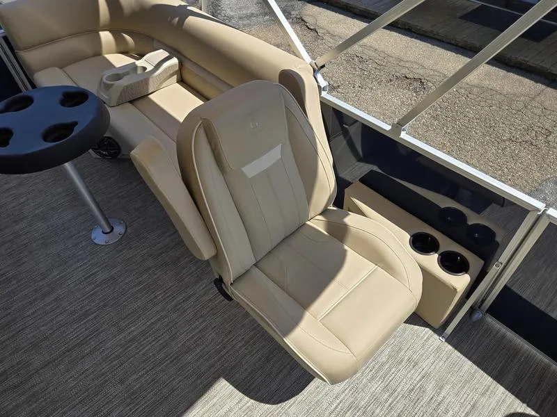 Slide: The Image of Luxurious seating on 2026 Godfrey Xperience 2286 SBX Sport Tube boat, featuring beige upholstery and cup holders. - 11