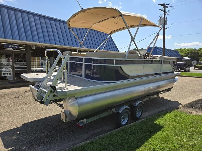 Slide: The Image of 2026 Godfrey Xperience 2286 SBX Sport Tube pontoon boat on trailer, parked outdoors. - 5