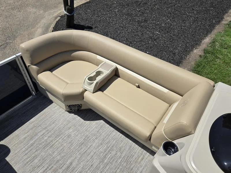 Slide: The Image of Luxurious seating on 2026 Godfrey Xperience 2286 SBX Sport Tube boat, featuring beige upholstery and cup holders. - 7