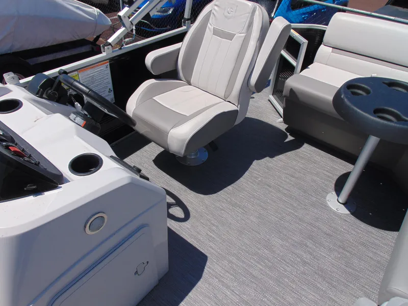 Slide: The Image of Interior of 2022 Godfrey Sweetwater 1880 CX boat with captain's chair and seating area. - 13