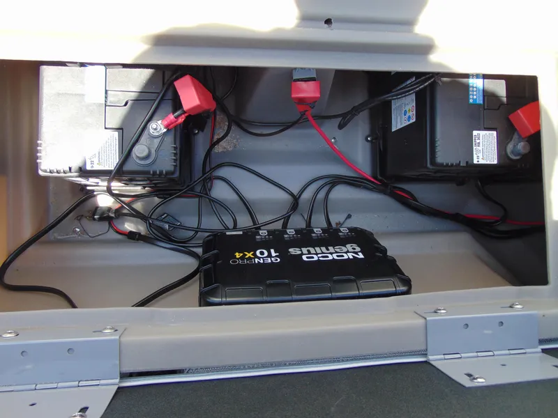 Slide: The Image of Battery compartment of 2022 Godfrey Sweetwater 1880 CX with NOCO Genius charger. - 15