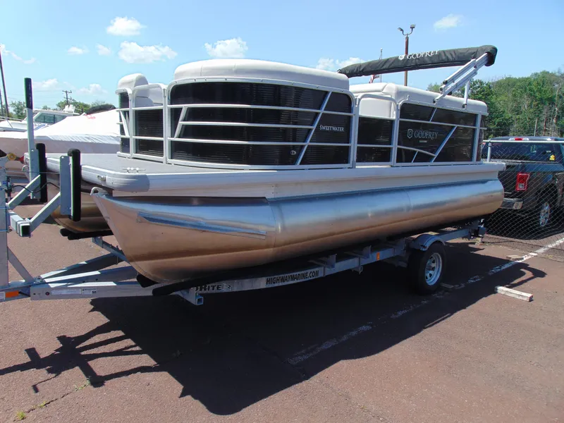 Slide: The Image of 2022 Godfrey Sweetwater 1880 CX pontoon boat on trailer, parked outdoors. - 3