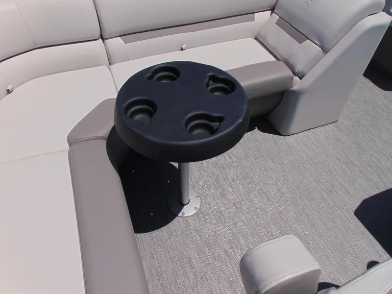 Slide: The Image of 2022 Godfrey Sweetwater 1880 CX boat interior with cupholder table and cushioned seating. - 7