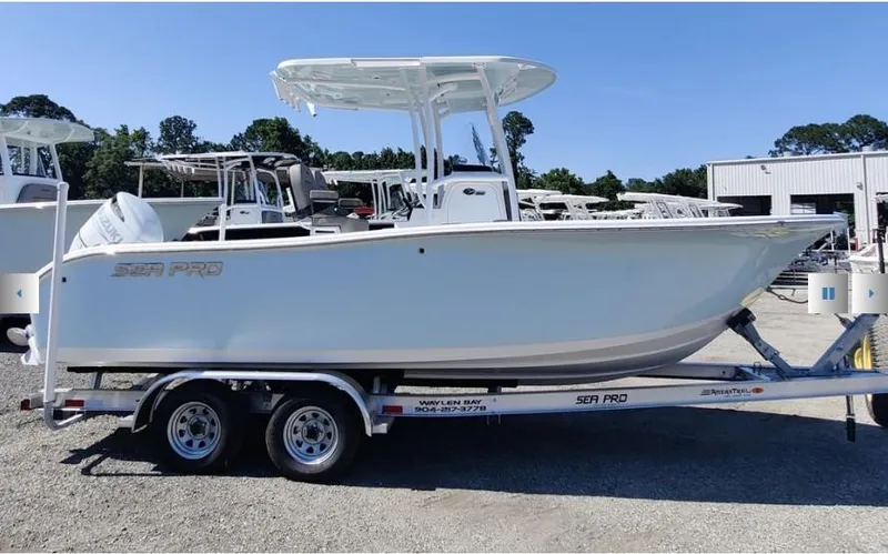 The Image of 2024 Sea Pro 222 Center Console boat on trailer, parked outdoors. - 1