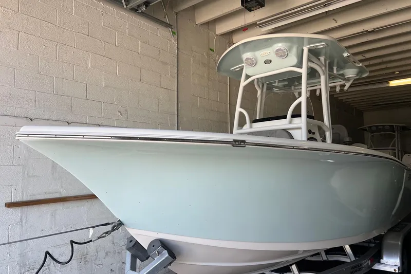 Slide: The Image of 2024 Sea Pro 222 Center Console boat in storage, showcasing sleek design and modern features. - 5