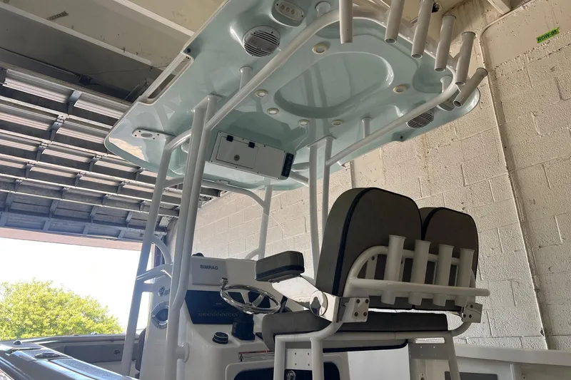 Slide: The Image of 2024 Sea Pro 222 Center Console boat interior with seating and overhead storage. - 6