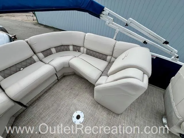 Slide: The Image of 2017 Bennington R23 boat with beige seating and blue canopy. - 21