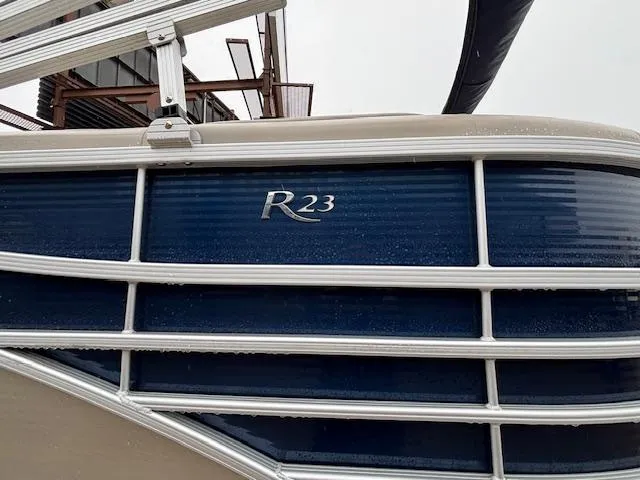 Slide: The Image of 2017 Bennington R23 pontoon boat with blue and silver detailing. - 4