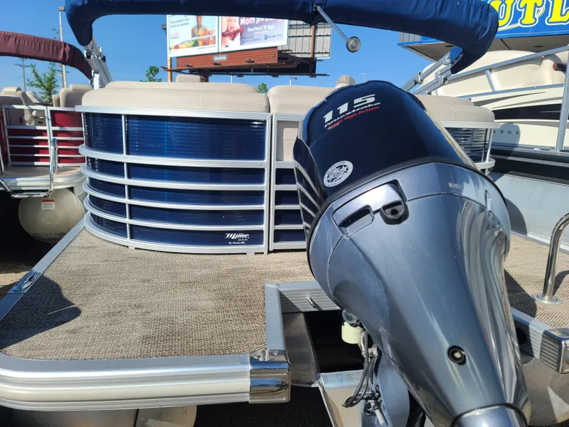 Slide: The Image of 2017 Bennington R23 pontoon boat with 115 horsepower outboard motor, docked under clear skies. - 5