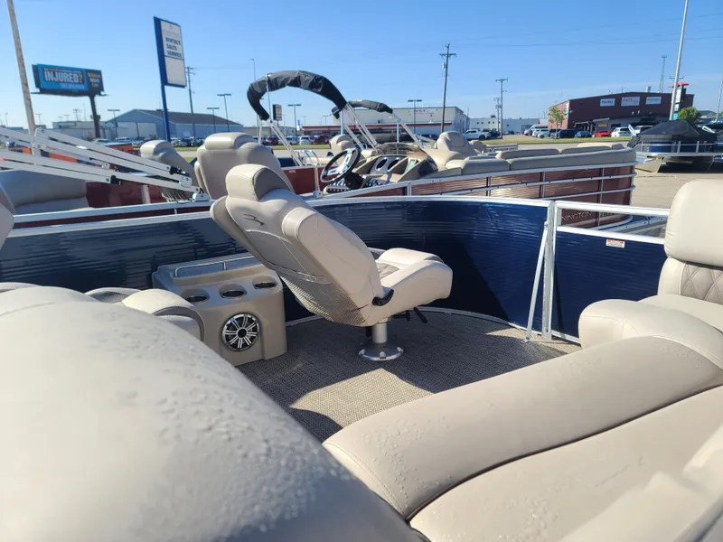 Slide: The Image of 2017 Bennington R23 pontoon boat interior with beige seating and steering console. - 8