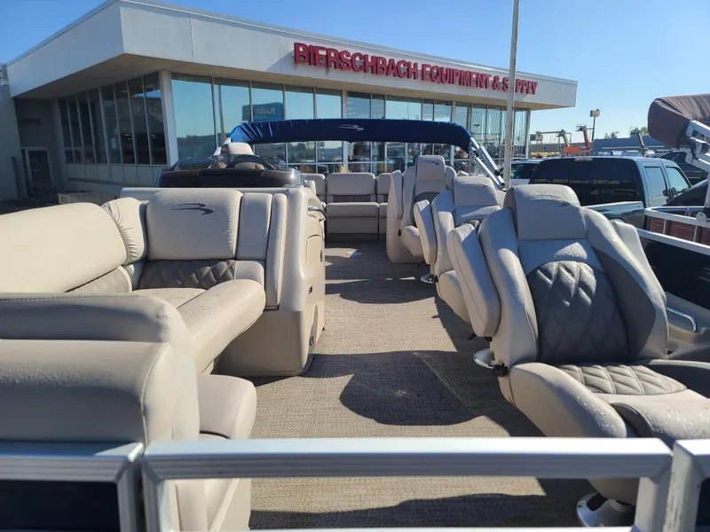 Slide: The Image of 2017 Bennington R23 pontoon boat with beige seating at dealership. - 9