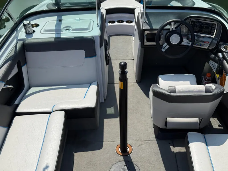 Slide: The Image of Interior of a 2014 Nautique Sport 200 boat with seating and steering console. - 10