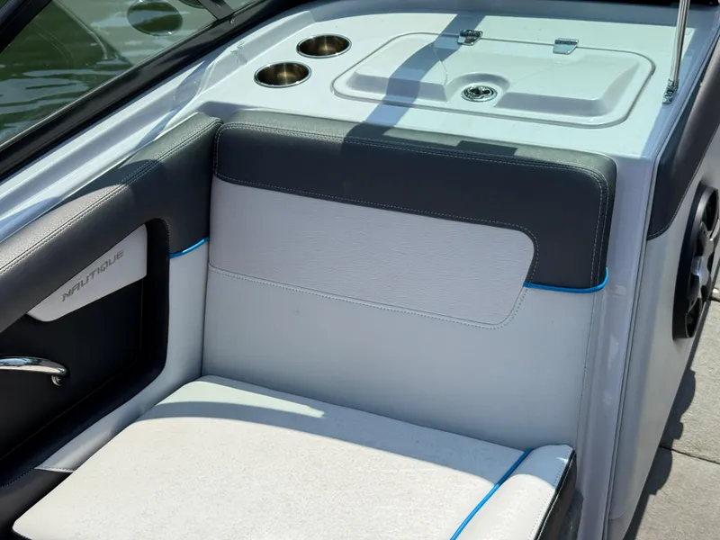 Slide: The Image of 2014 Nautique Sport 200 boat interior with cushioned seating and cup holders. - 13