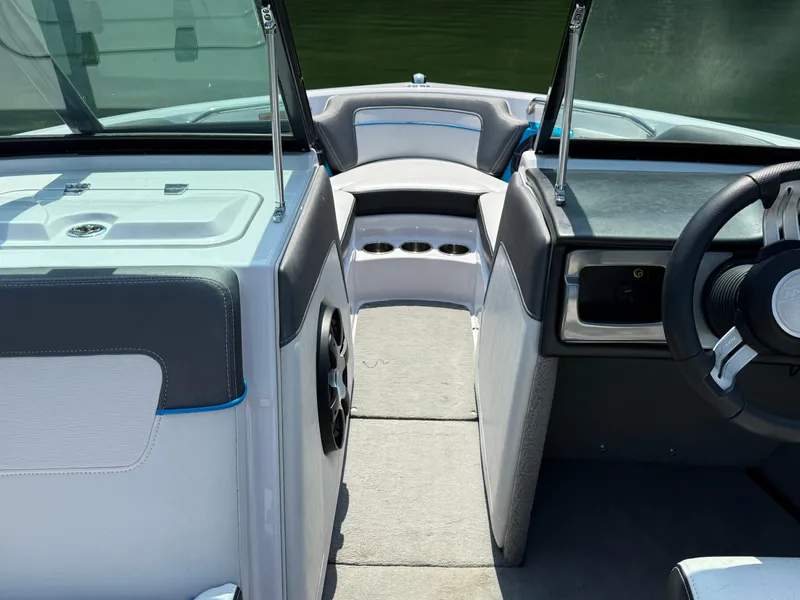 Slide: The Image of 2014 Nautique Sport 200 boat interior with steering wheel and seating area. - 15