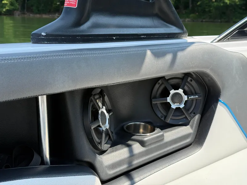 Slide: The Image of 2014 Nautique Sport 200 boat interior with Polk Audio speakers and cup holder. - 22