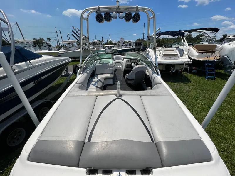 Slide: The Image of 2004 MasterCraft MariStar 210 VRS boat with spacious seating and sleek design, parked outdoors. - 10