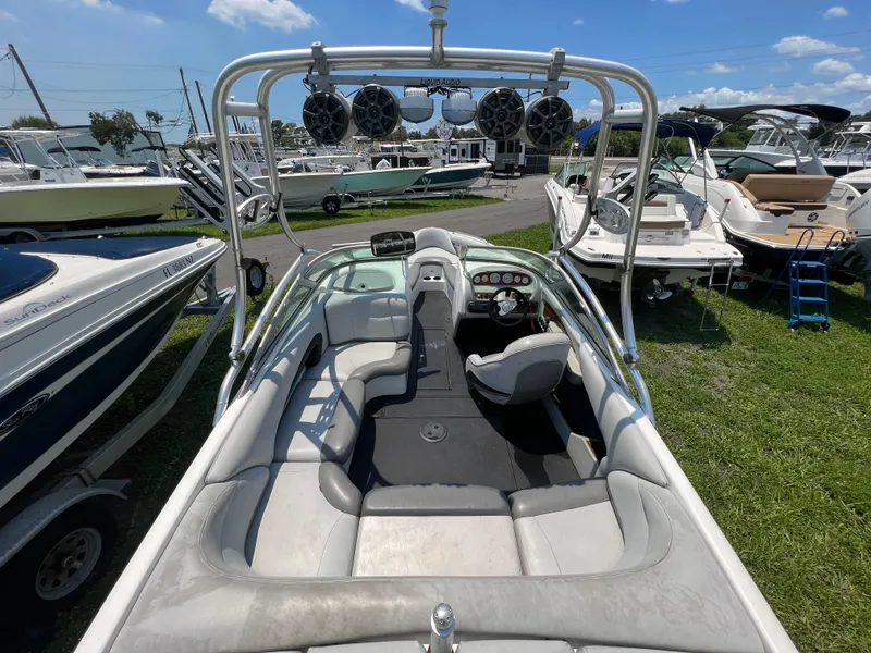Slide: The Image of 2004 MasterCraft MariStar 210 VRS boat interior with seating and audio system, parked outdoors. - 11