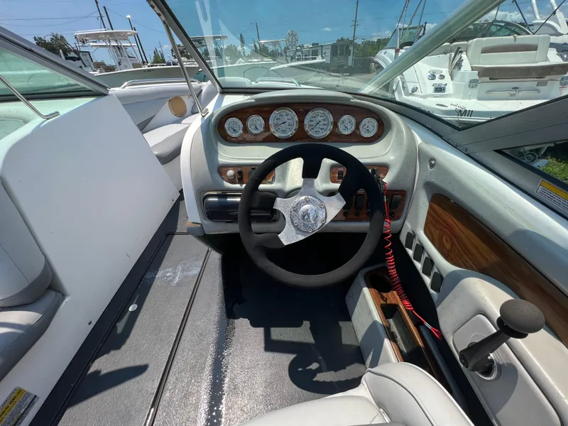 Slide: The Image of 2004 MasterCraft MariStar 210 VRS boat cockpit with steering wheel and dashboard controls. - 15