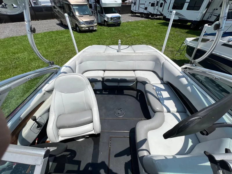 Slide: The Image of 2004 MasterCraft MariStar 210 VRS boat interior with white seating and steering wheel. - 22