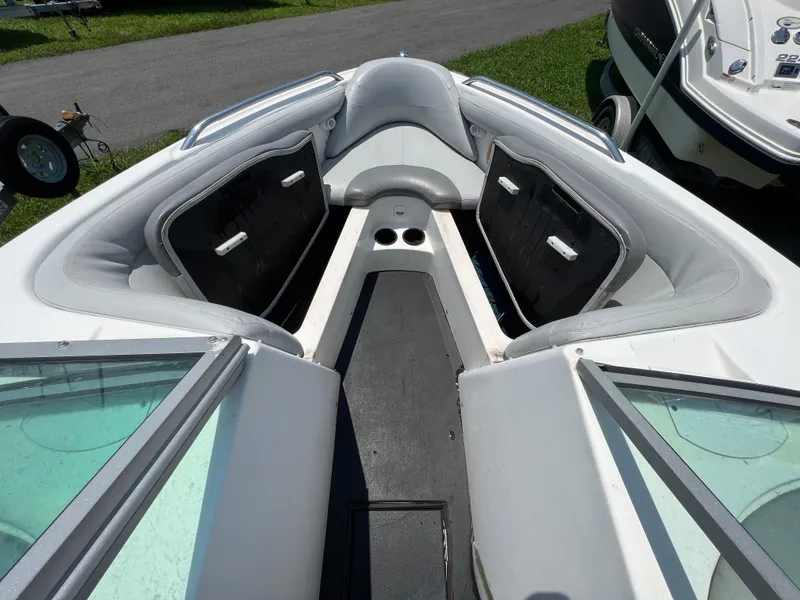Slide: The Image of 2004 MasterCraft MariStar 210 VRS boat interior with gray seating and storage compartments. - 23