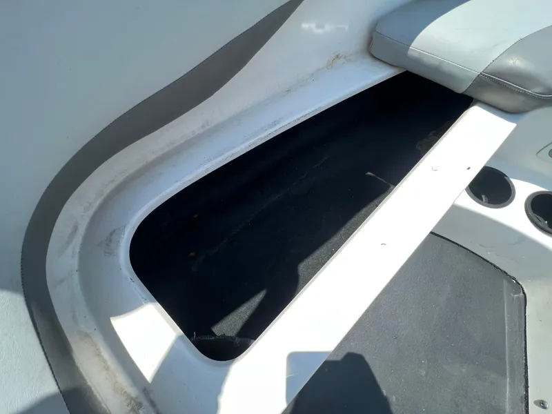 Slide: The Image of 2004 MasterCraft MariStar 210 VRS boat interior storage compartment with seating and cup holders. - 24