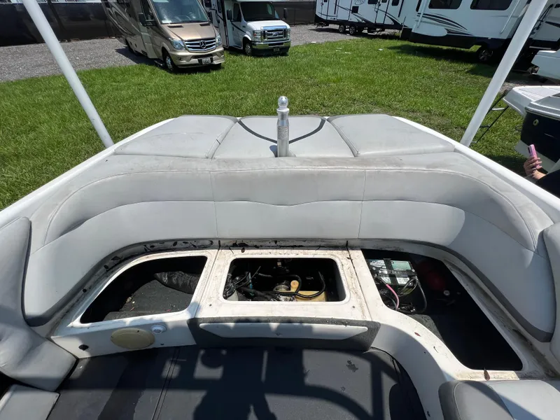 Slide: The Image of 2004 MasterCraft MariStar 210 VRS boat interior with open engine compartment, parked near RVs. - 26