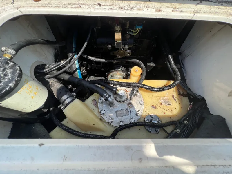 Slide: The Image of Engine compartment of a 2004 MasterCraft MariStar 210 VRS boat, showing hoses and components. - 28