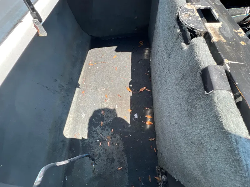 Slide: The Image of Interior of a 2004 MasterCraft MariStar 210 VRS boat with visible wear and debris. - 34