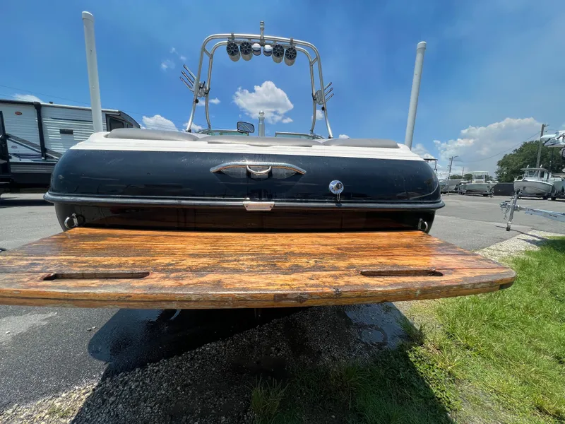 Slide: The Image of 2004 MasterCraft MariStar 210 VRS boat with wooden swim platform, parked outdoors. - 8
