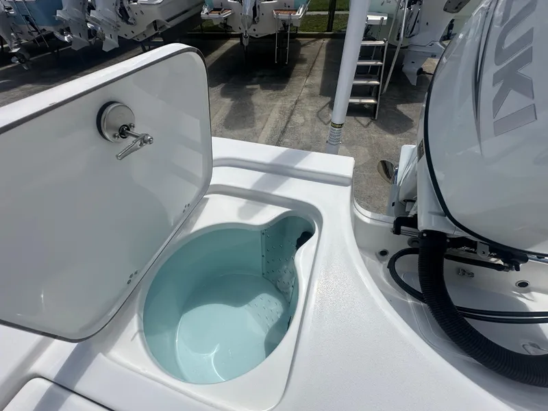Slide: The Image of 2025 Sea Pro 230 Bay boat with open livewell and Suzuki outboard motor. - 14