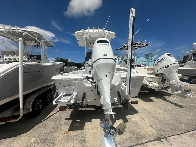 Slide: The Image of 2025 Sea Pro 230 Bay boat with powerful outboard motor, displayed in a sunny marina. - 3