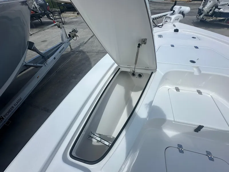 Slide: The Image of 2025 Sea Pro 230 Bay boat storage compartment open, showcasing interior space. - 7