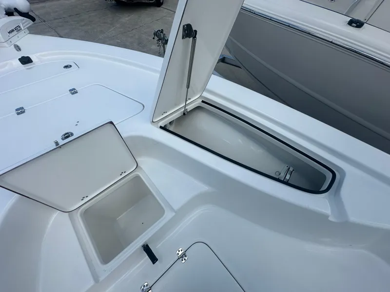 Slide: The Image of 2025 Sea Pro 230 Bay boat storage compartments open on deck. - 9