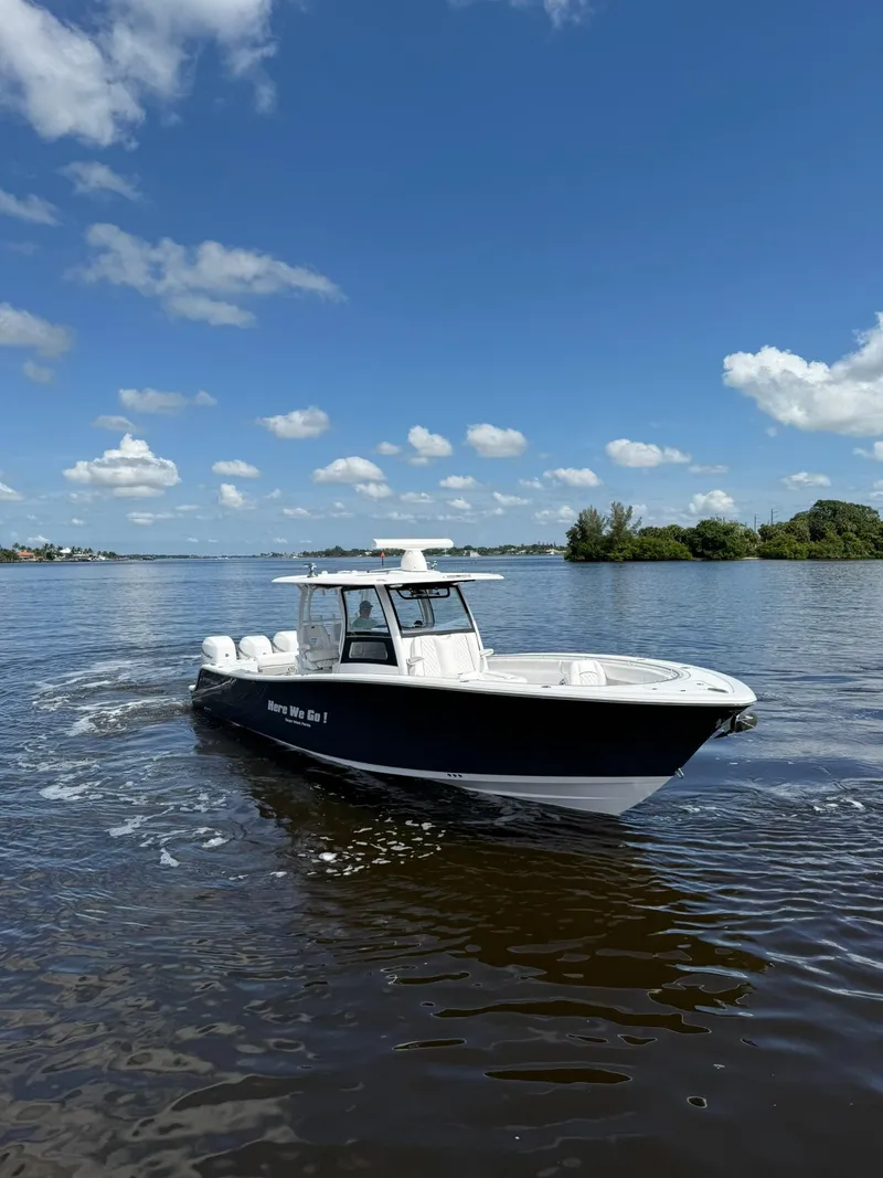 The Image of 2021 Sportsman Open 352 Center Console boat cruising on a sunny day. - 0