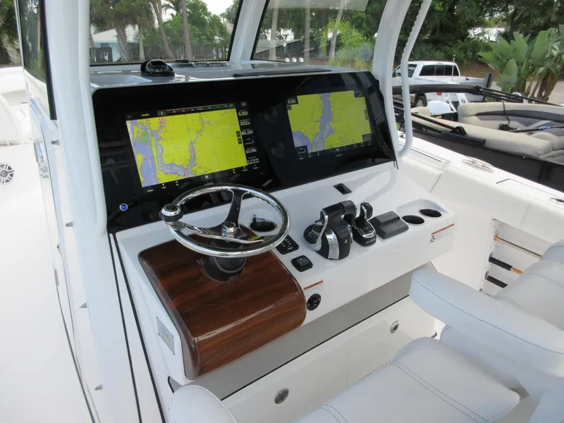 Slide: The Image of 2021 Sportsman Open 352 Center Console dashboard with dual navigation screens and steering wheel. - 12